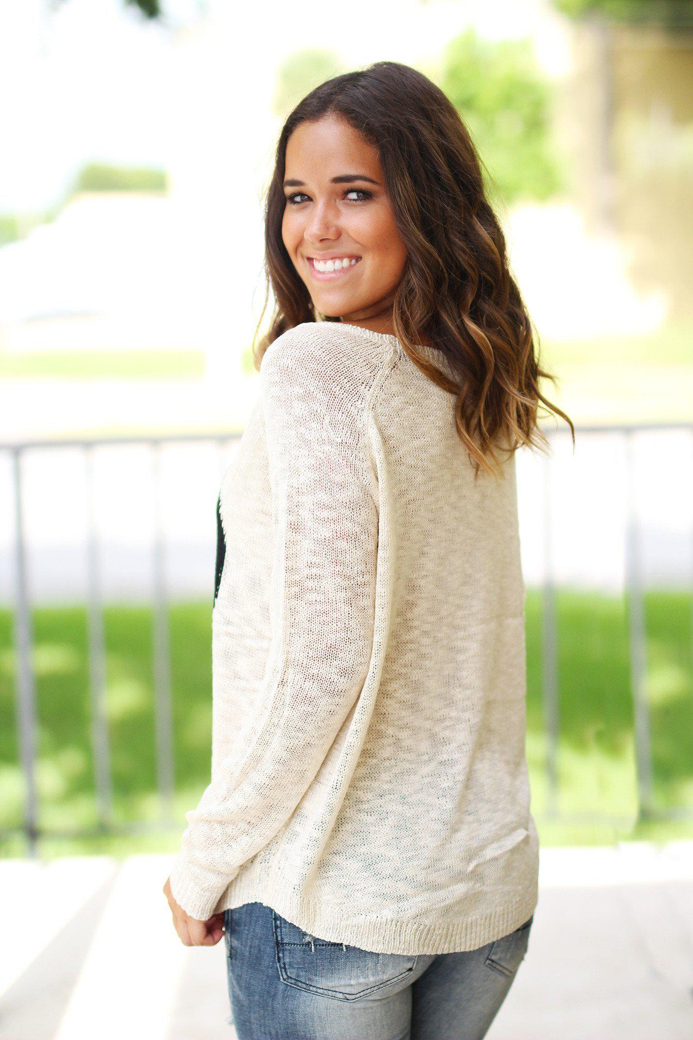 Charming Ivory Knit Women's Sweater Adorned With A Black Heart Design