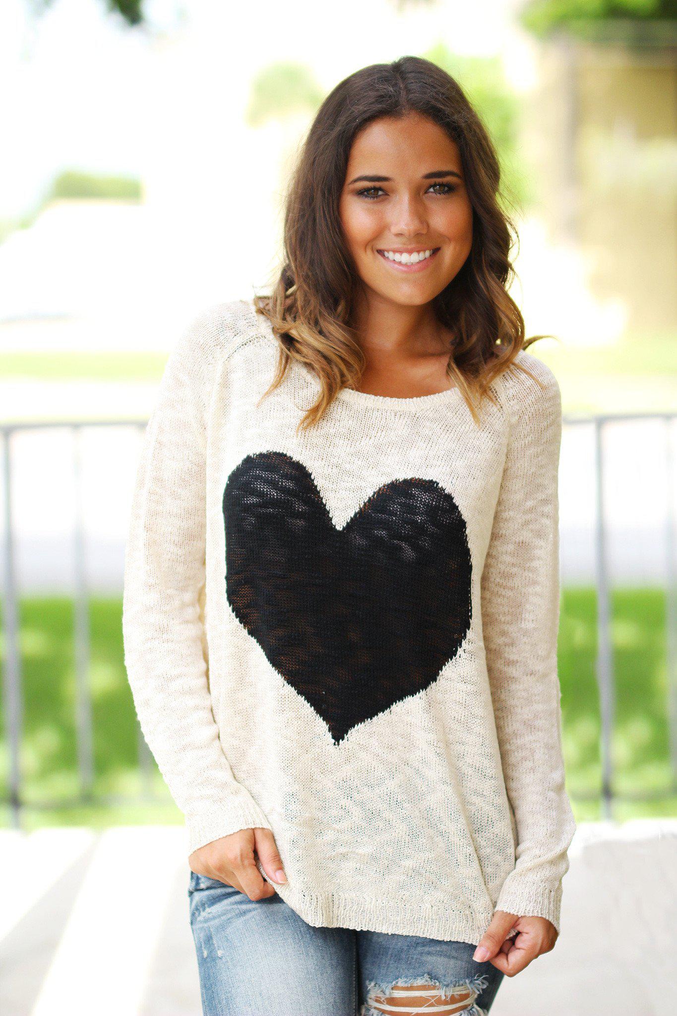 Charming Ivory Knit Women's Sweater Adorned With A Black Heart Design