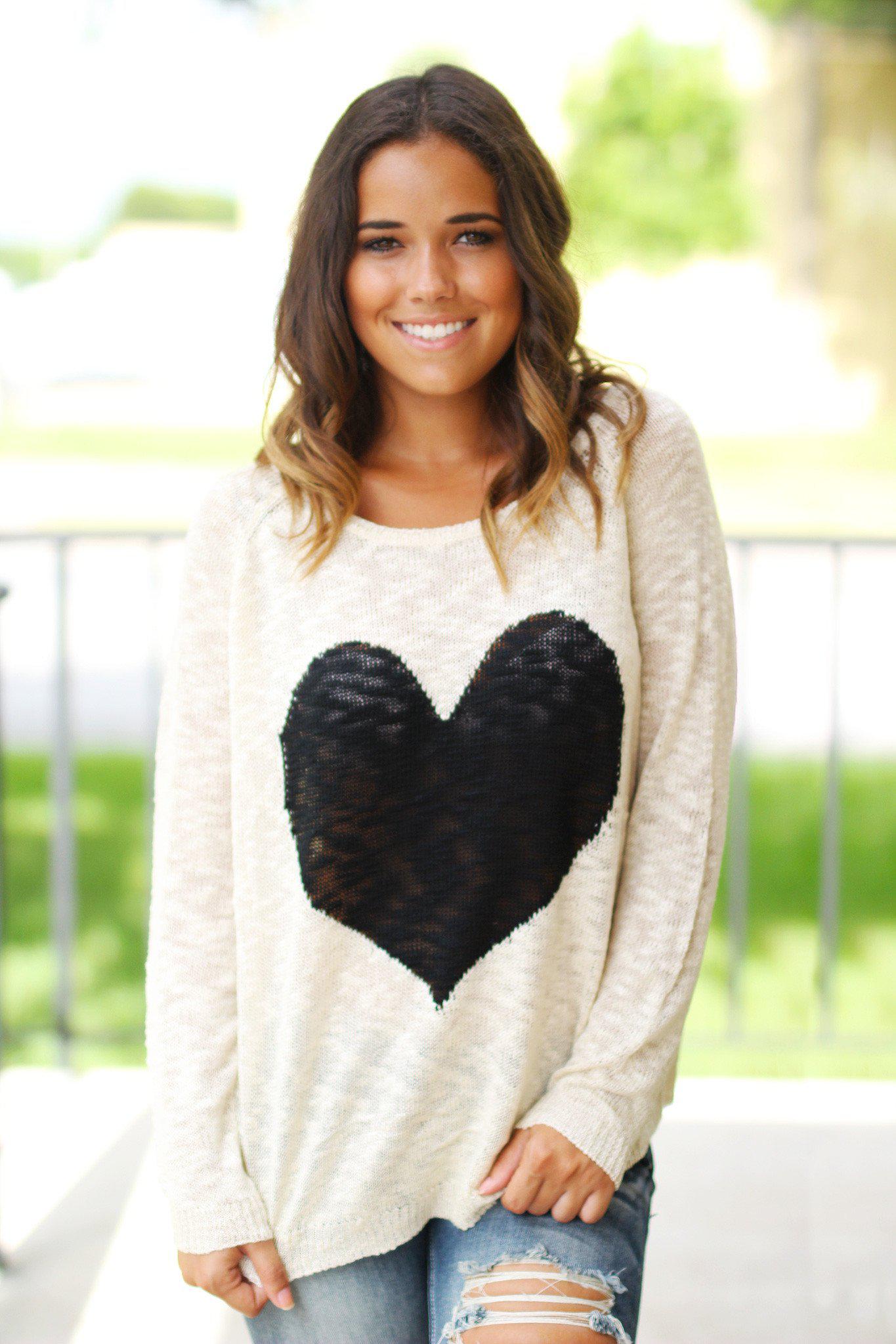 Charming Ivory Knit Women's Sweater Adorned With A Black Heart Design