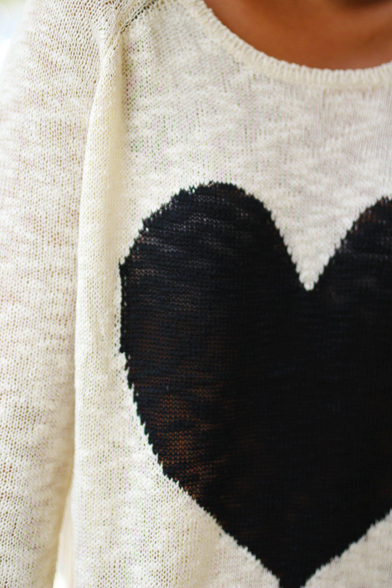 Charming Ivory Knit Women's Sweater Adorned With A Black Heart Design